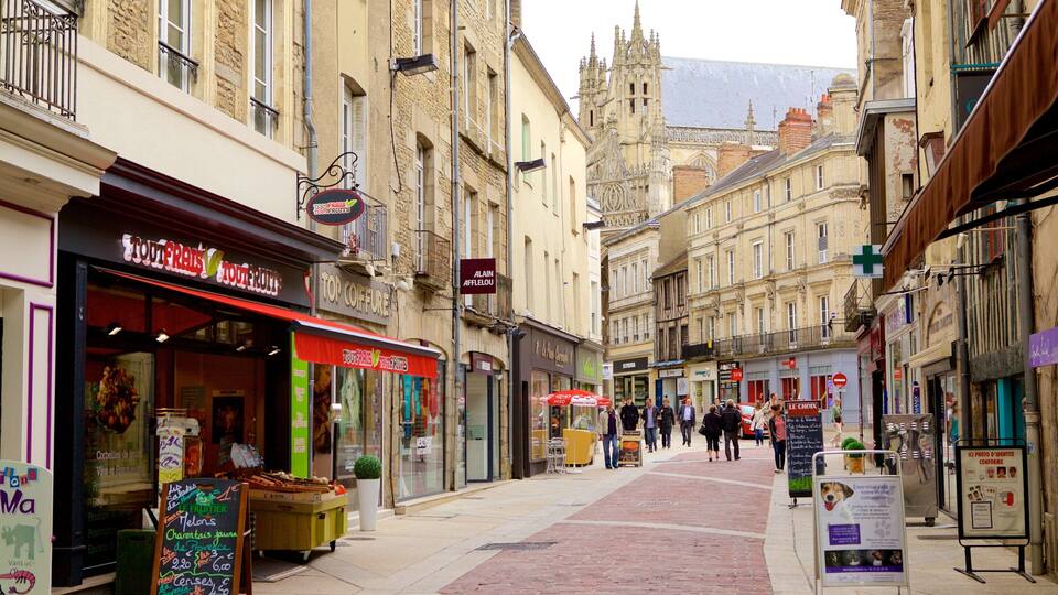 A street with shops and a historic building in the background.