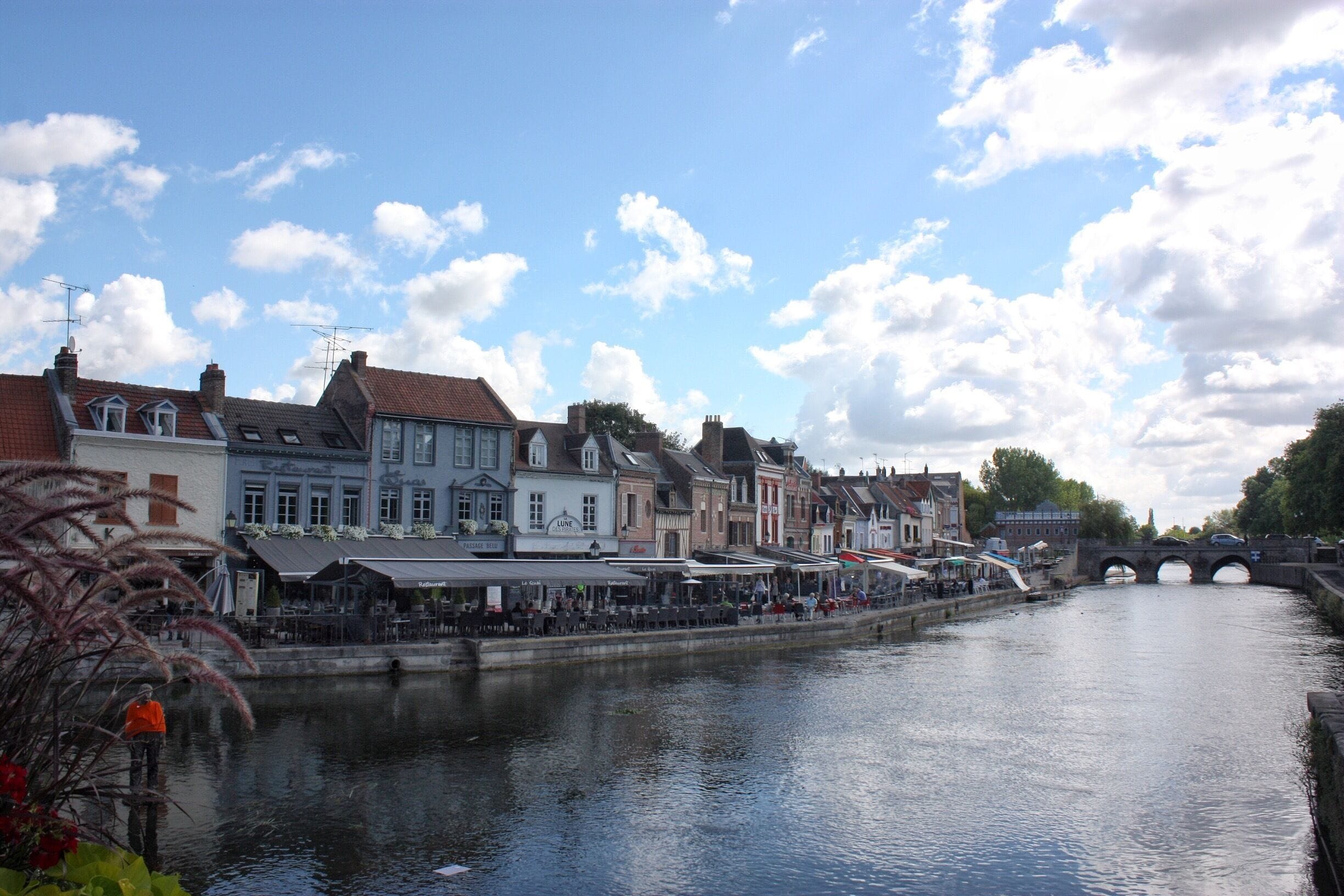A canal with buildings and a bridge.
