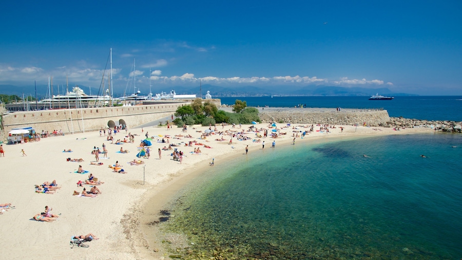 Antibes which includes a sandy beach as well as a large group of people