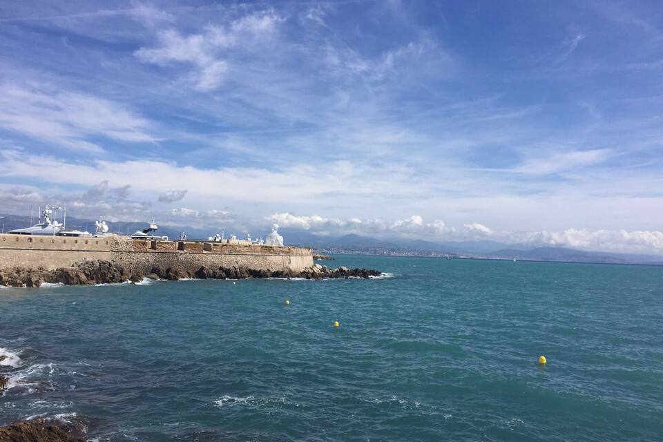 A coastal fortification with a clear sky and calm sea.