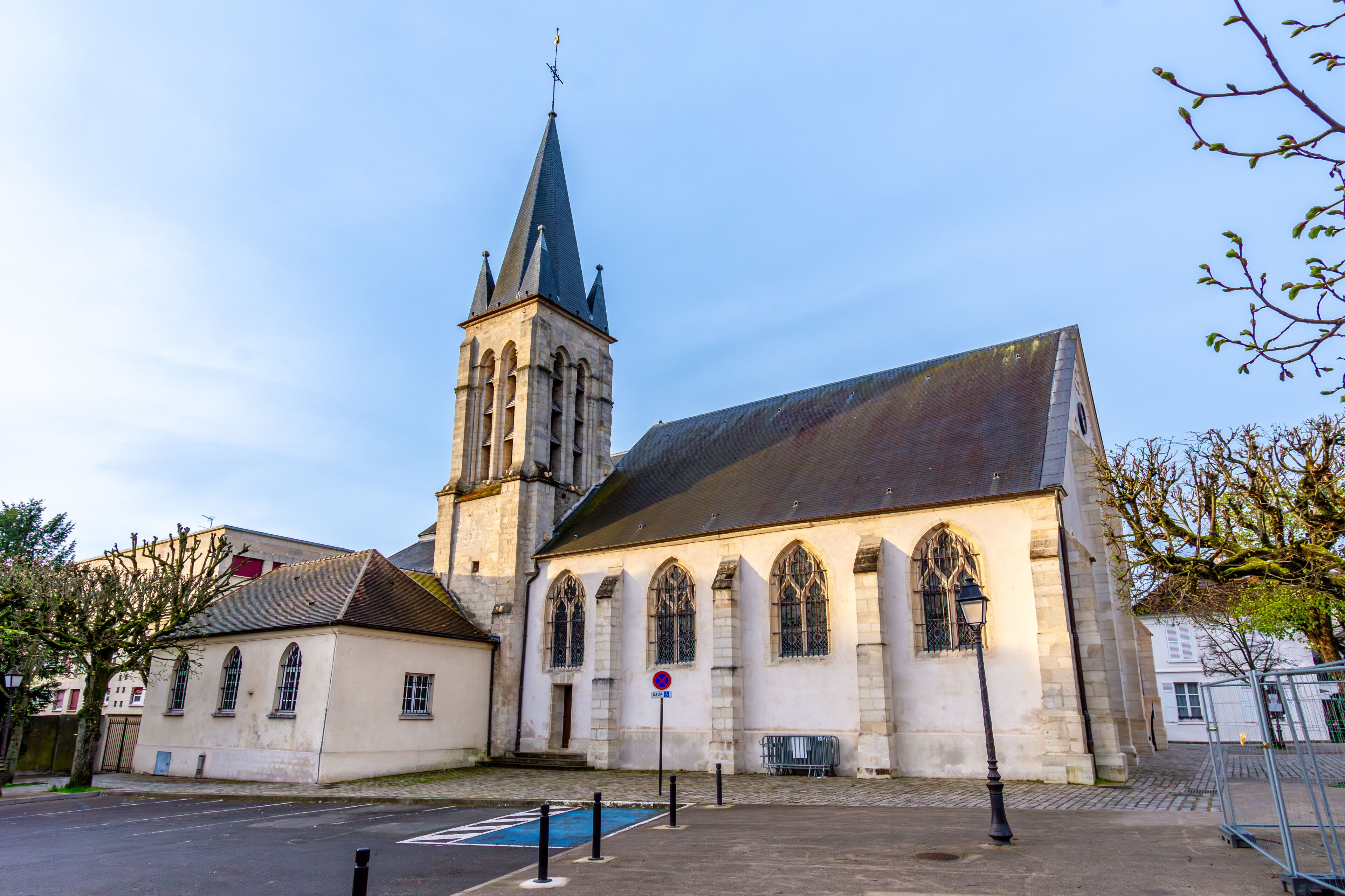 A church with a tall spire and arched windows.