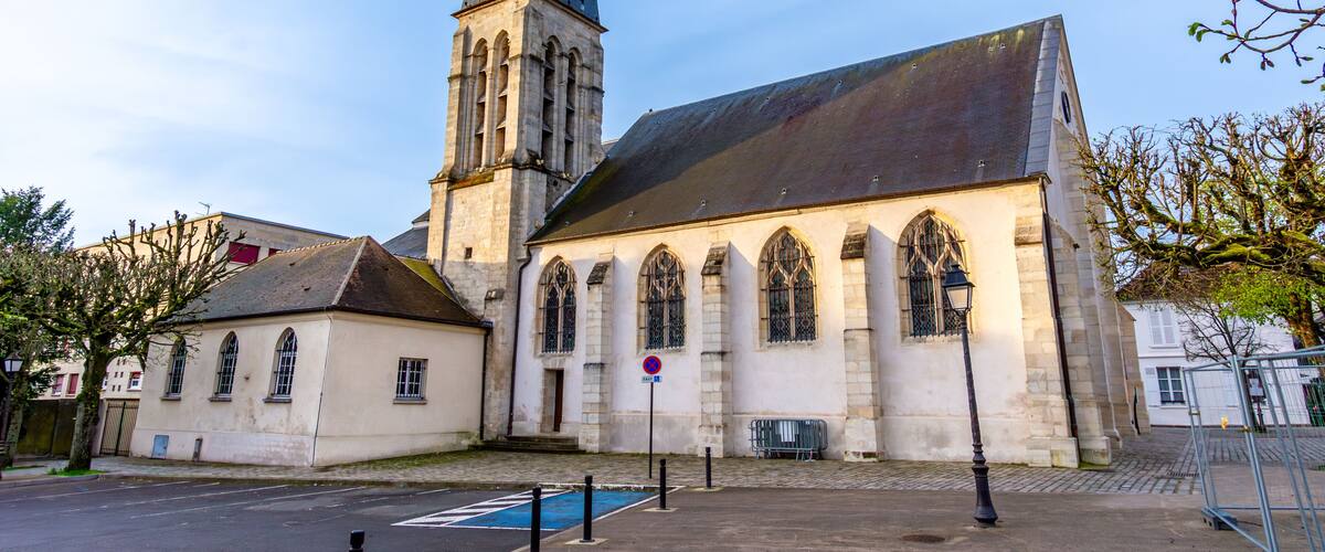 A church with a tall spire and arched windows.