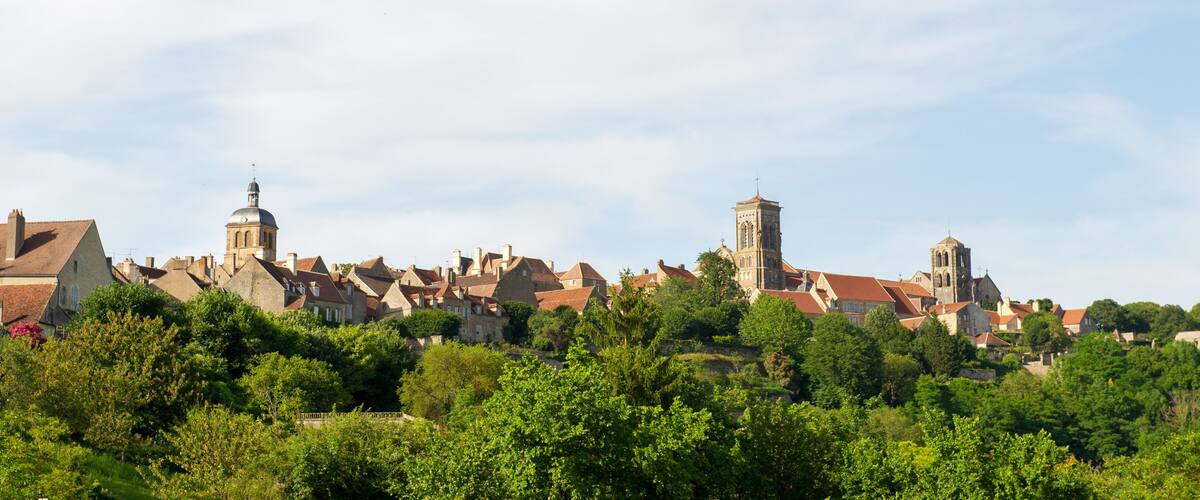 A town with historic buildings, including a church with a dome and a bell tower.
