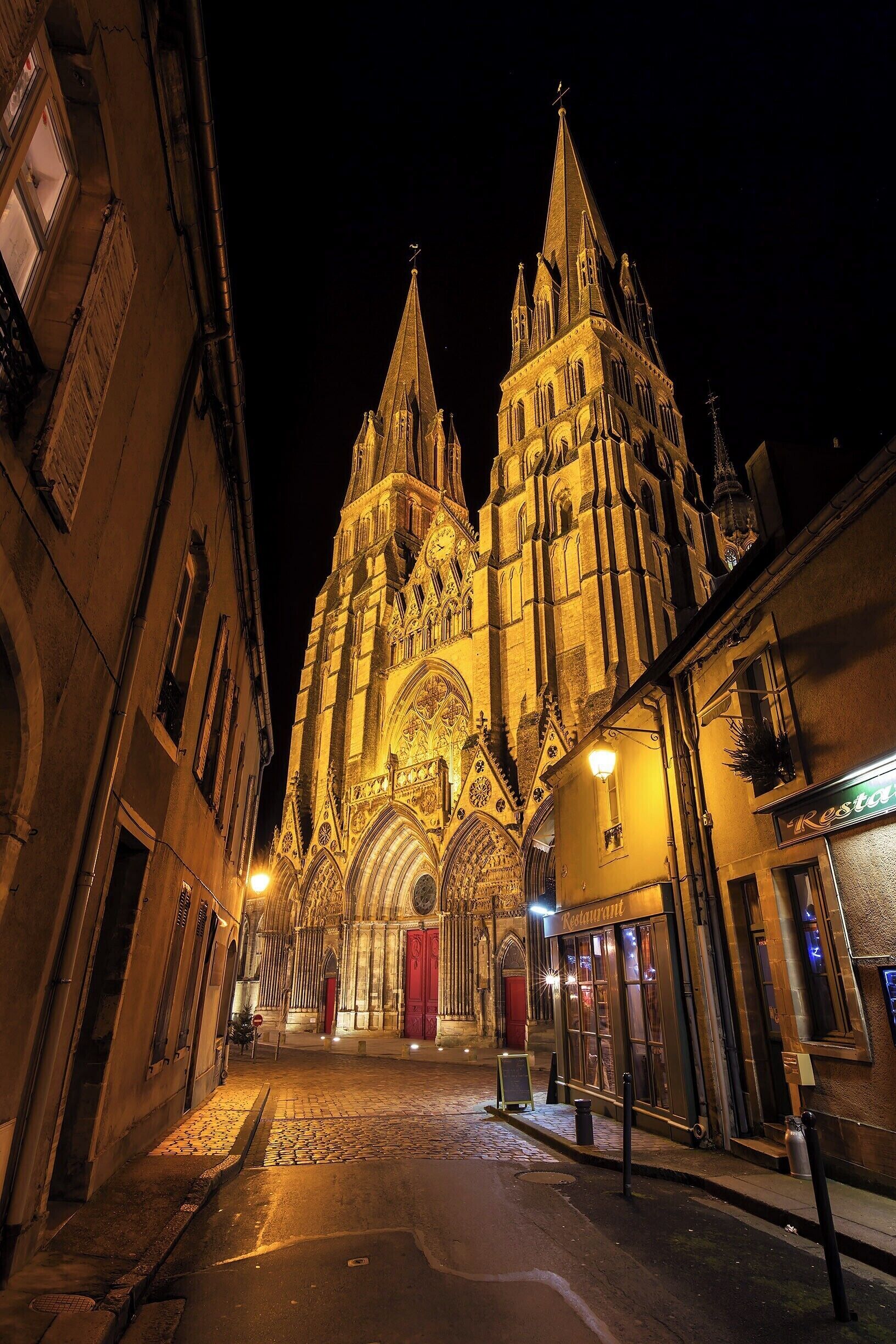 A Gothic cathedral with intricate architecture and a red door at its entrance.