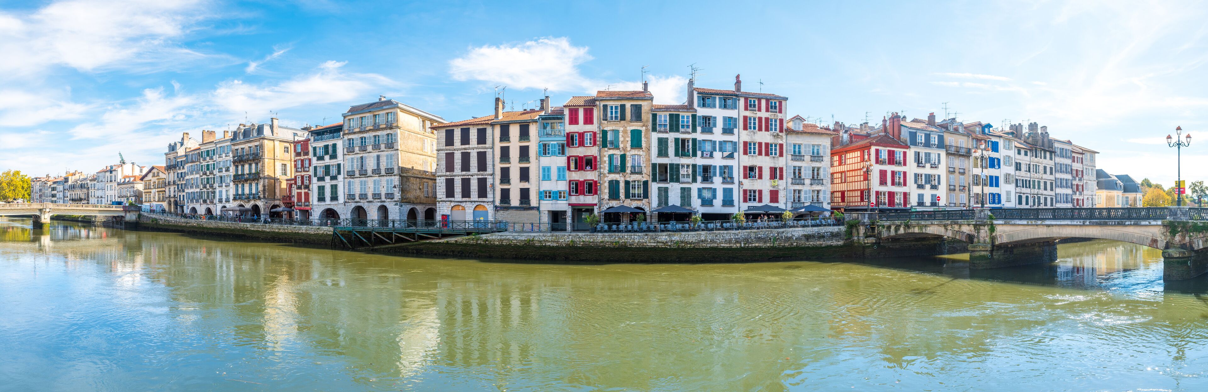 A river with colorful buildings along the banks.