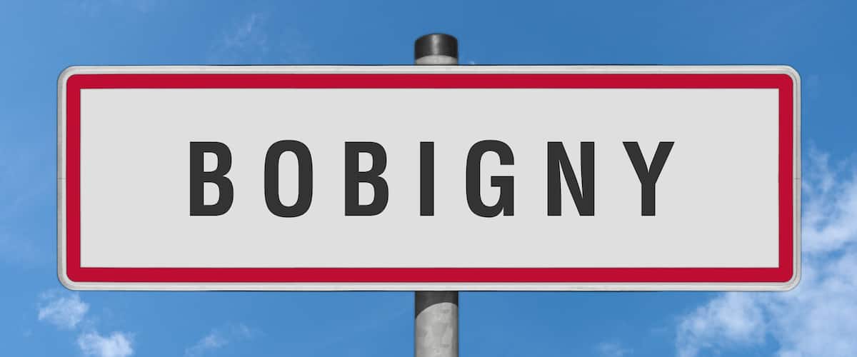 A road sign with the name 'BOBIGNY' against a clear blue sky.