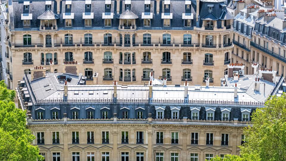 A multi-story building with ornate balconies and a classic architectural style.