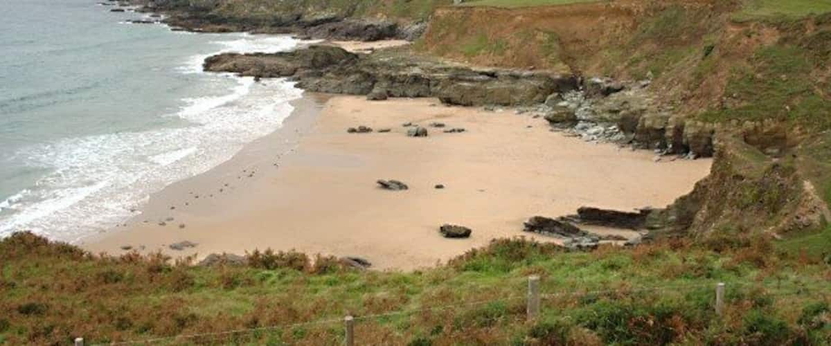 Gara Beach A deserted sandy beach in calm sea conditions.