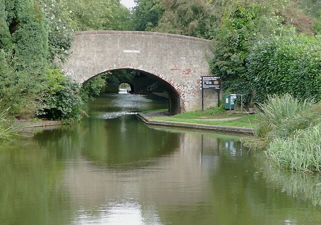 Curdworth Bridge, Birmingham and Fazeley Canal, Warwickshire Beyond the bridge is Curdworth Tunnel which is 57 yards (52 metres) in length. The smart sign invites people to visit the post office and convenience stores in the village.