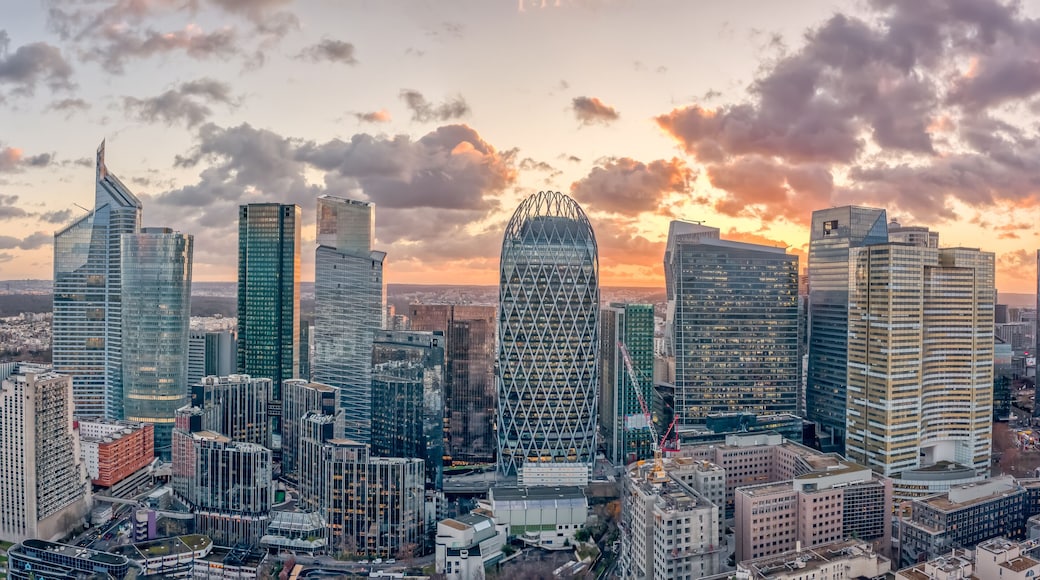 Aerial panoramic drone shot of La Defense skycraper in Paris CBD skyscraper complex business district with clouds during sunset