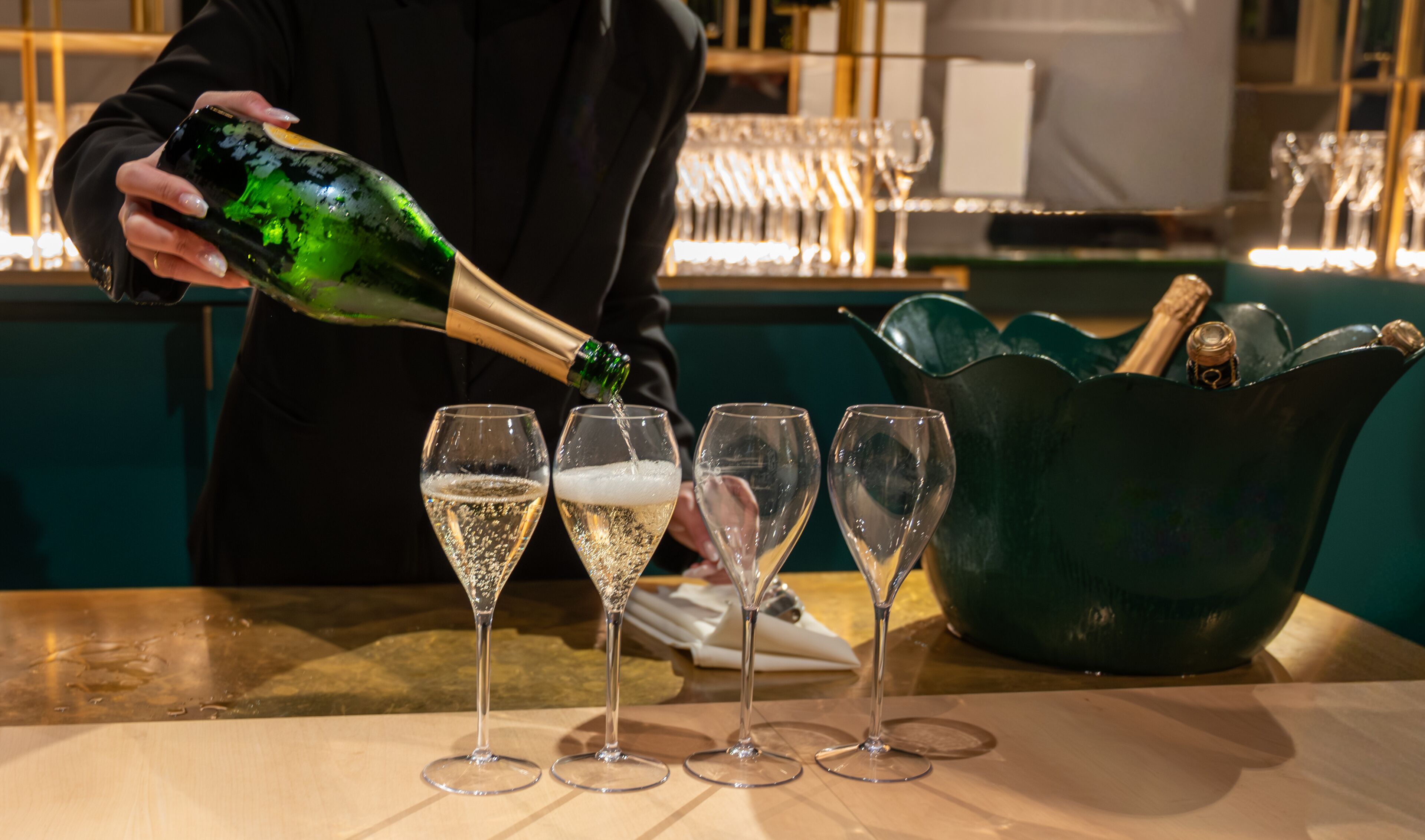 Pouring in glasses of french sparkling wine champagne with little bubbles, tasting wine, celebration, wedding or champagne tour with visit of caves, Reims, France