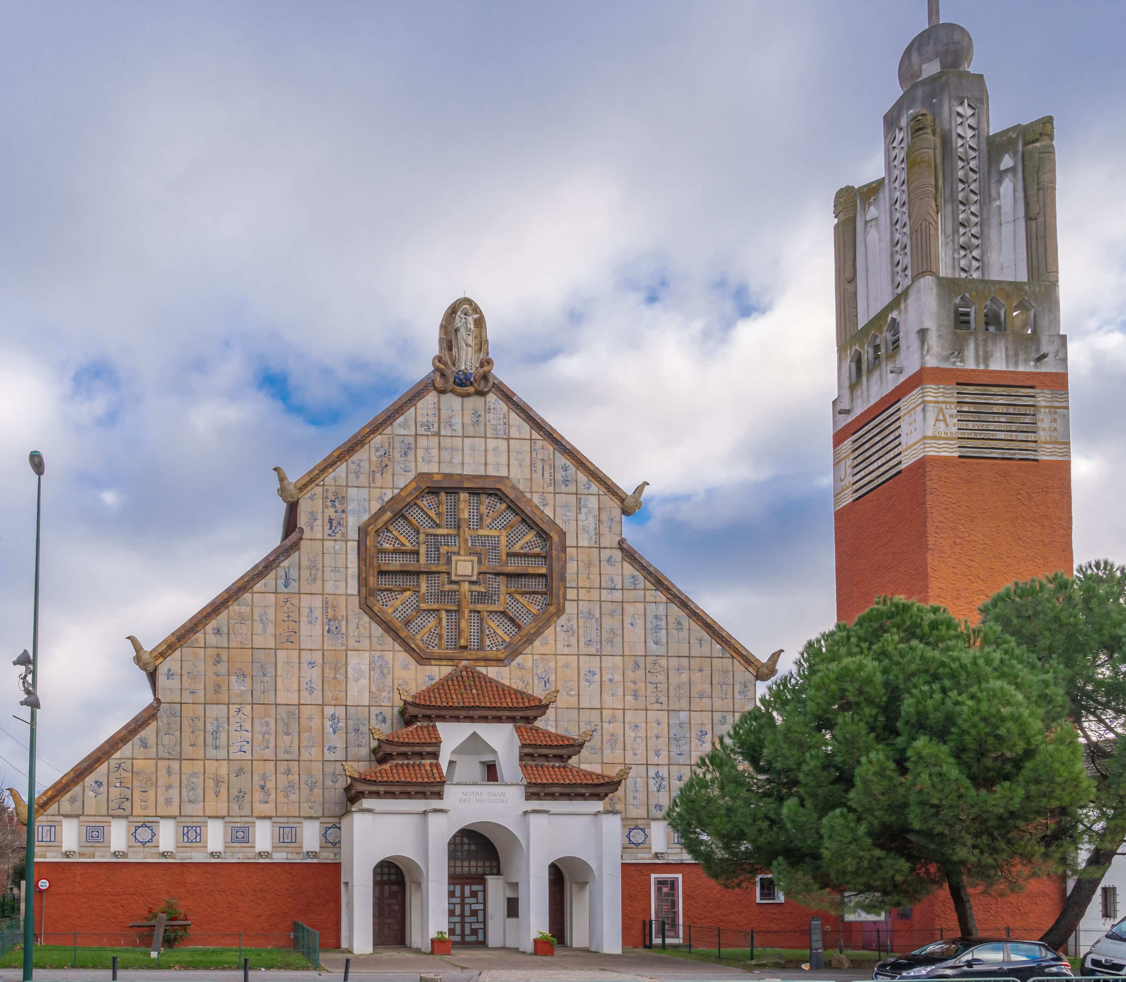 A church with a large stained glass window and a tall tower.