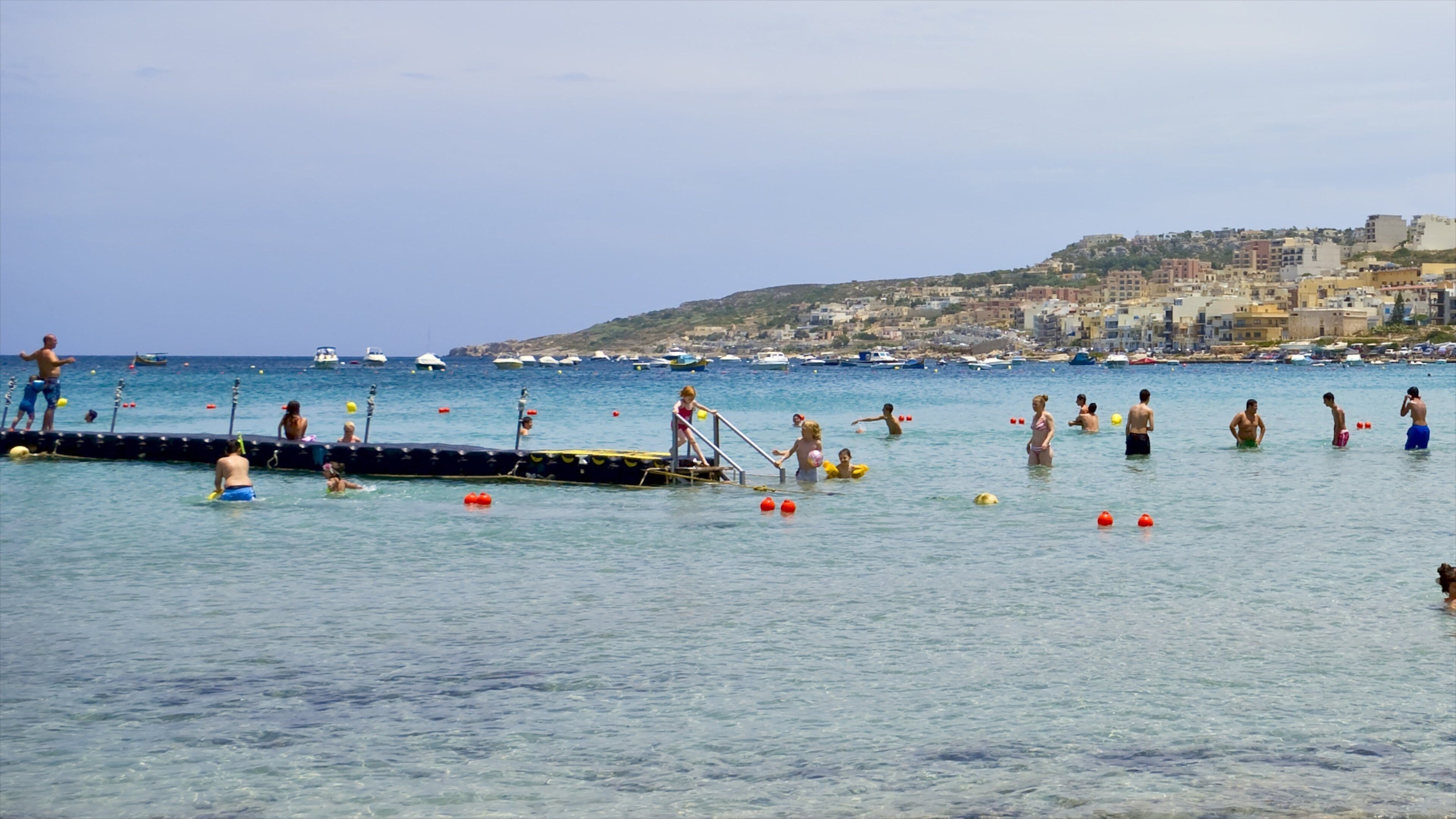 Mellieha featuring general coastal views and swimming as well as a large group of people