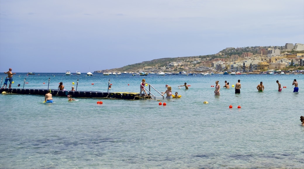 Mellieha featuring general coastal views and swimming as well as a large group of people
