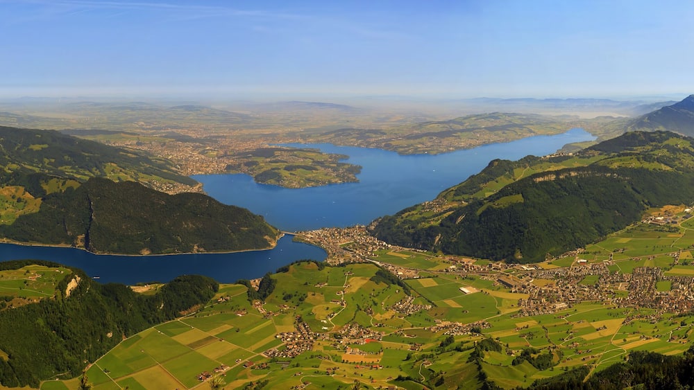 Magnificent panoramic aerial views of central Switzerland, mountains, Lake Lucerne as you ascend the Cabrio cable car up Mount Stanserhorn in Switzerland. City of Stans.