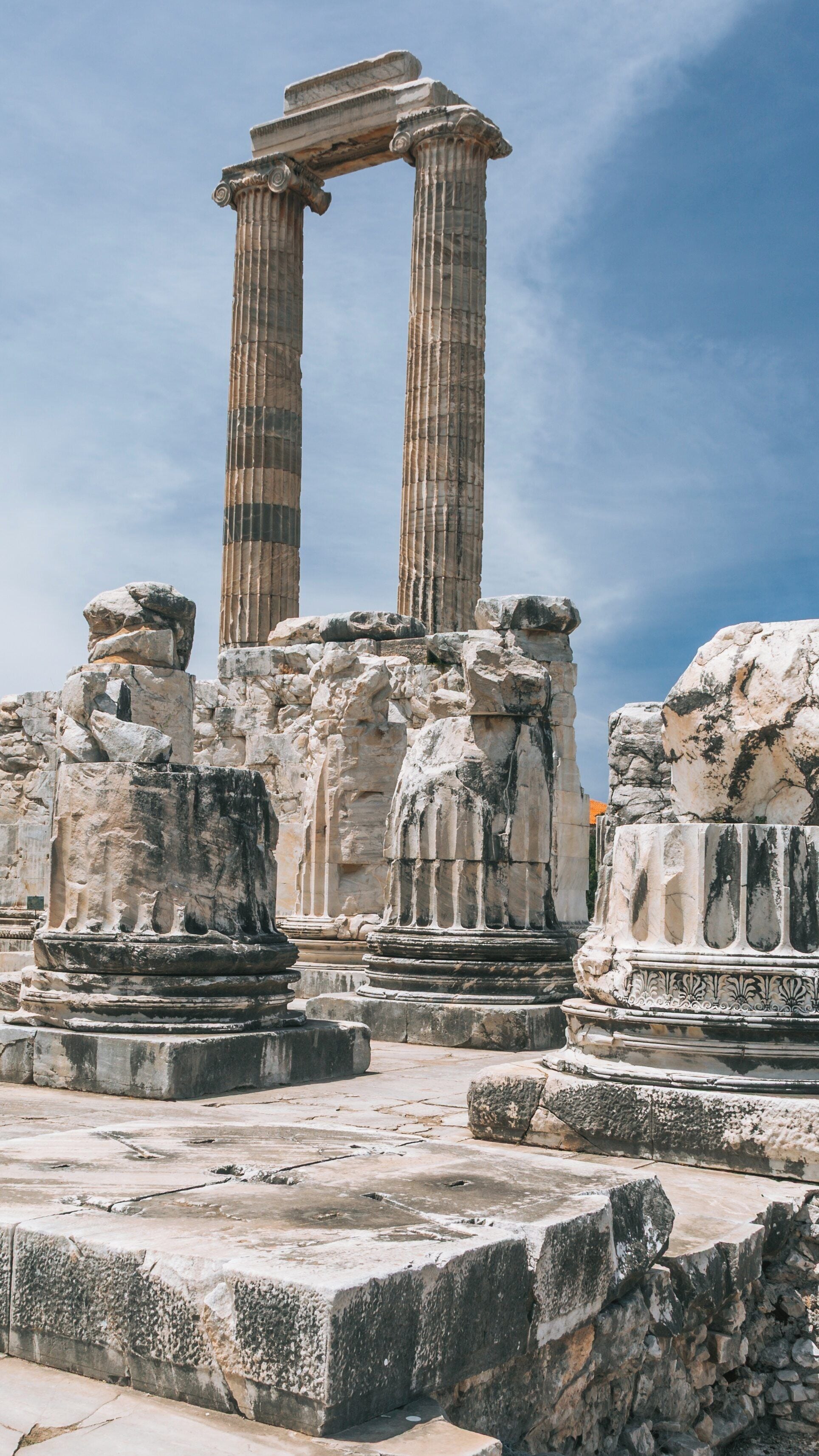 Exploring the ancient ruins of the Temple of Apollo and Athena in Side, Antalya Region, Türkiye under a clear blue sky