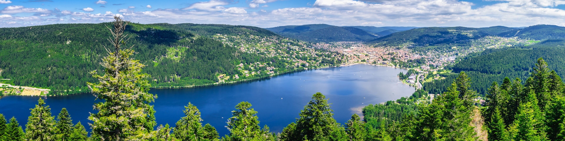 A lake surrounded by dense forests and mountains.