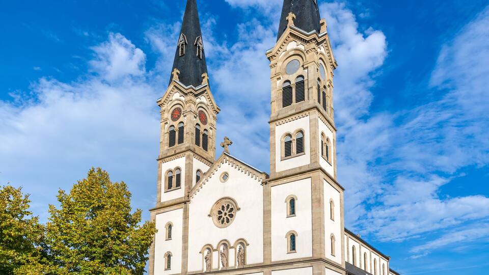A large church with two tall towers and a clock.