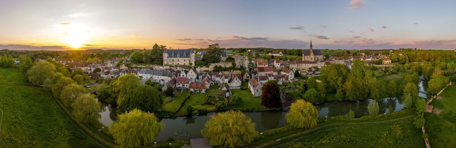 Aerial sunset view of Montresor medieval castle with a Renaissance mansion in Indre et Loire, on a rocky overhand dominating the valley, on of the most beautiful villages of France