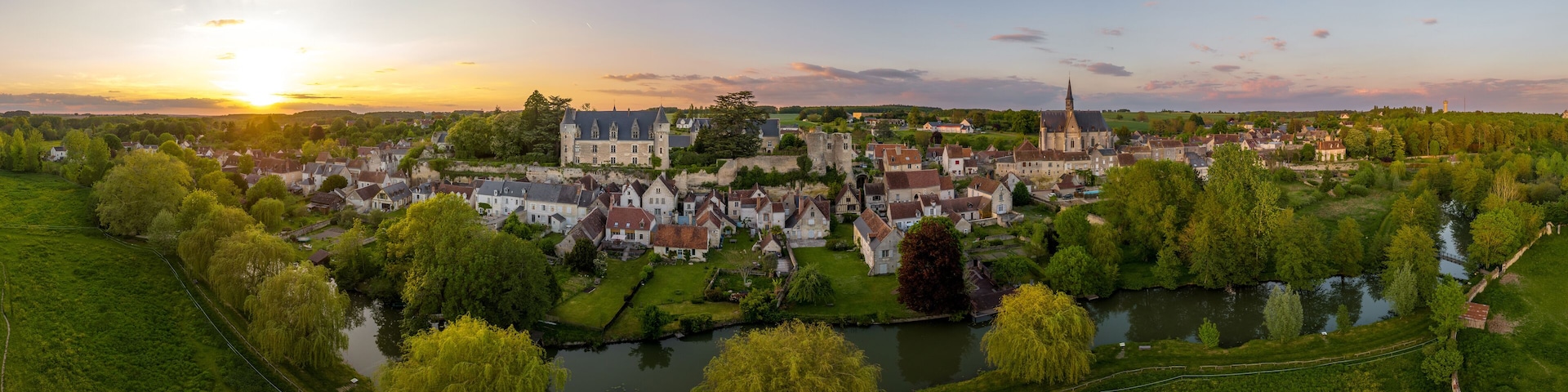 Aerial sunset view of Montresor medieval castle with a Renaissance mansion in Indre et Loire, on a rocky overhand dominating the valley, on of the most beautiful villages of France