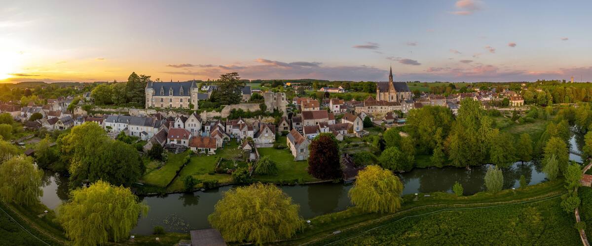 A historic town with a castle, church, and river.