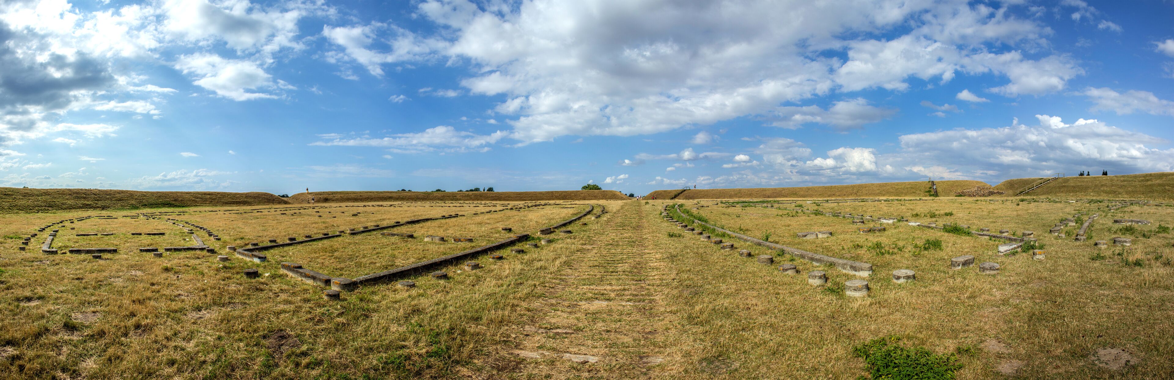 A historical site with stone pathways and circular formations.