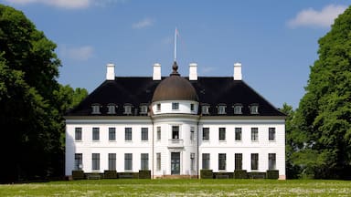 A large white building with a central dome and multiple chimneys.