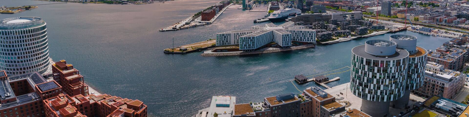 Aerial panorama of Indre Osterbro, Nordhavnen districts. New modern district in Copenhagen, Denmark. Beautiful modern buildings, Portland Towers and UN.