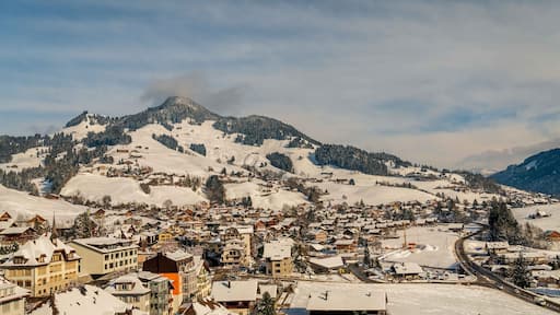 Winter landscape of Swiss village in Switzerland. Mountain, sky and Swiss chalet.