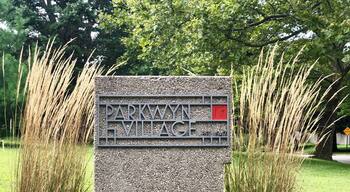 Parkwyn Village is a neighborhood of Kalamazoo, Michigan that was founded in the 1940s by a group of young scientists, employed at the Upjohn Company, who had a vision for a "congenial housing community." They purchased a 47-acre tract of land in 1946. By the fall of that year, they prevailed upon world-famous architect, Frank Lloyd Wright, to layout the community and design affordable houses they could build themselves.
The homeowners pooled their resources so that they could buy materials in bulk, make their own concrete blocks, and do some of the work of building the homes. Wright's site plan would accommodate 40 lots of approximately 1-acre in size.
Wright's Usonian style homes were designed to be modular with a large living room and fireplace, a convenient kitchen, indirect lighting, heated concrete floors and built-in furniture and closets. The walls would be constructed of inexpensive concrete blocks accented with mahogany trim and an extensive wall of windows overlooking a naturally landscaped yard. Designed to control costs, they would have no attic, basement, visible roof, garage, gutters or downspouts. While only four of Parkwyn's homes are pure Wright designs, his concepts influenced the majority of homes in the neighborhood.