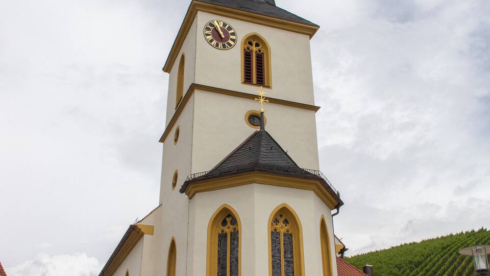 A church with a tall steeple and a clock.