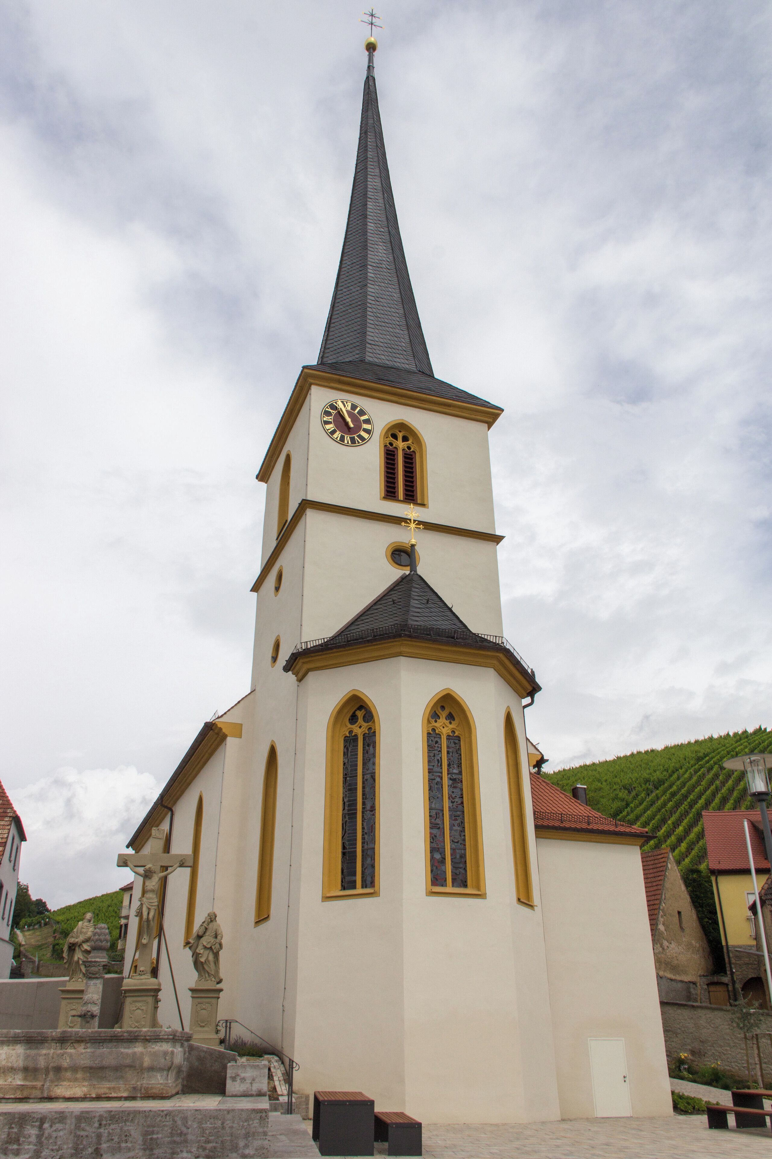 A church with a tall steeple and a clock.