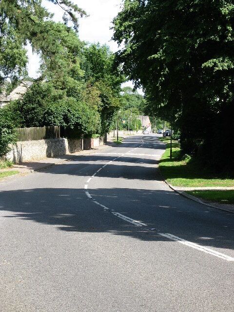 Cottesmore, Rutland. Looking NE along Main Street. Lots of trees in this village which is home to RAF Cottesmore.