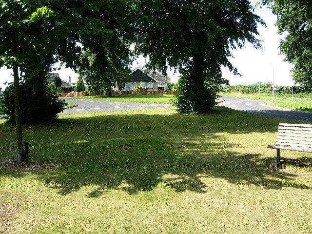 Cottesmore, Rutland. On the edge of the village between Ashwell Road and Burley Road there is a development of modern housing, visible here through the trees.