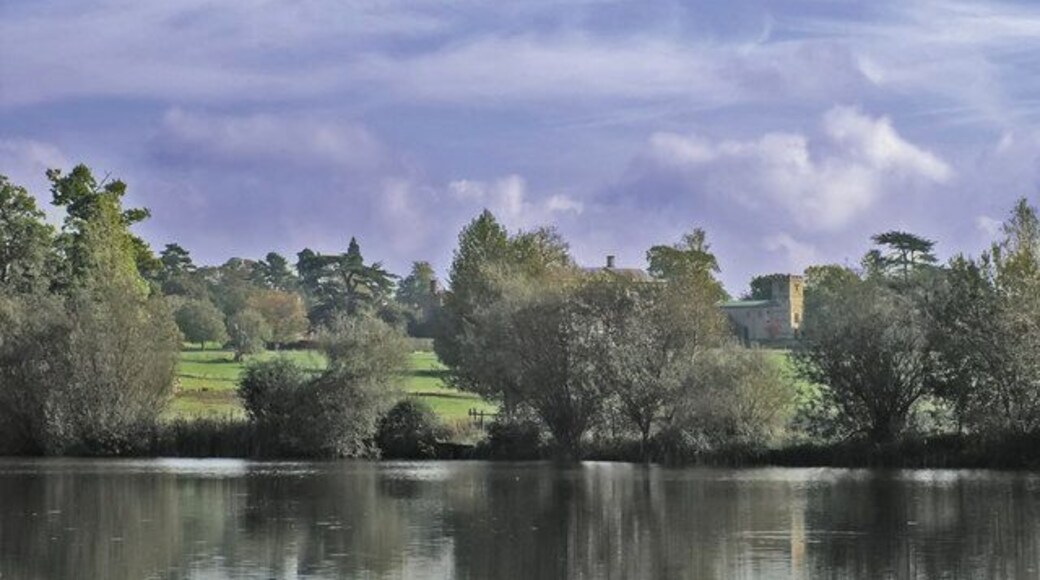 All Saints at Claydon House This view of the Church overlooks the lower lake at Claydon House. The house itself is hidden behind the trees to the left of the church.