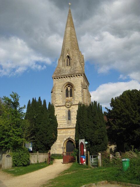 West tower and spire of St Michael and All Angels parish church, Steeple Claydon, Buckinghamshire. The tower is Decorated Gothic and has a broach spire, which is one that starts on a square base on a tower, and then builds up to a tapered octagonal top by means of triangular faces. Note the gold cockerel weathervane atop the spire.