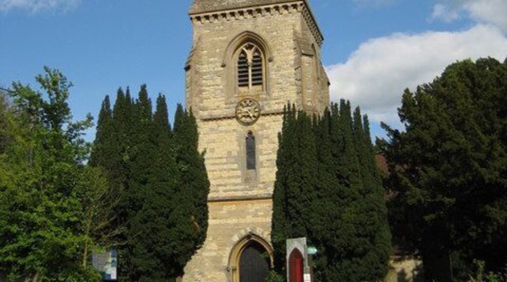 West tower and spire of St Michael and All Angels parish church, Steeple Claydon, Buckinghamshire. The tower is Decorated Gothic and has a broach spire, which is one that starts on a square base on a tower, and then builds up to a tapered octagonal top by means of triangular faces. Note the gold cockerel weathervane atop the spire.