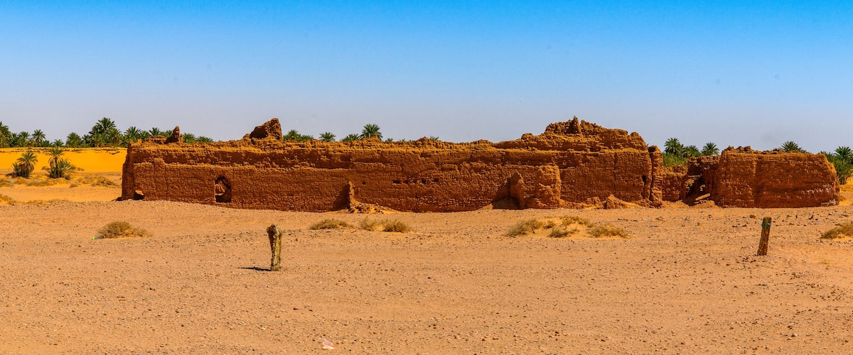 A large, ancient stone structure in a desert landscape.