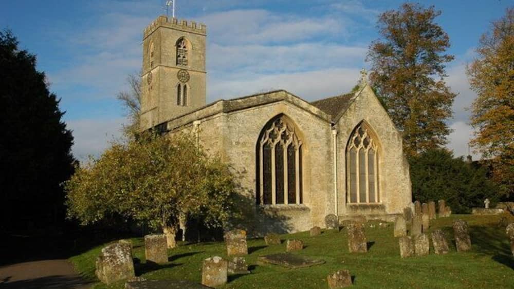 A church with a tall tower and large arched windows.
