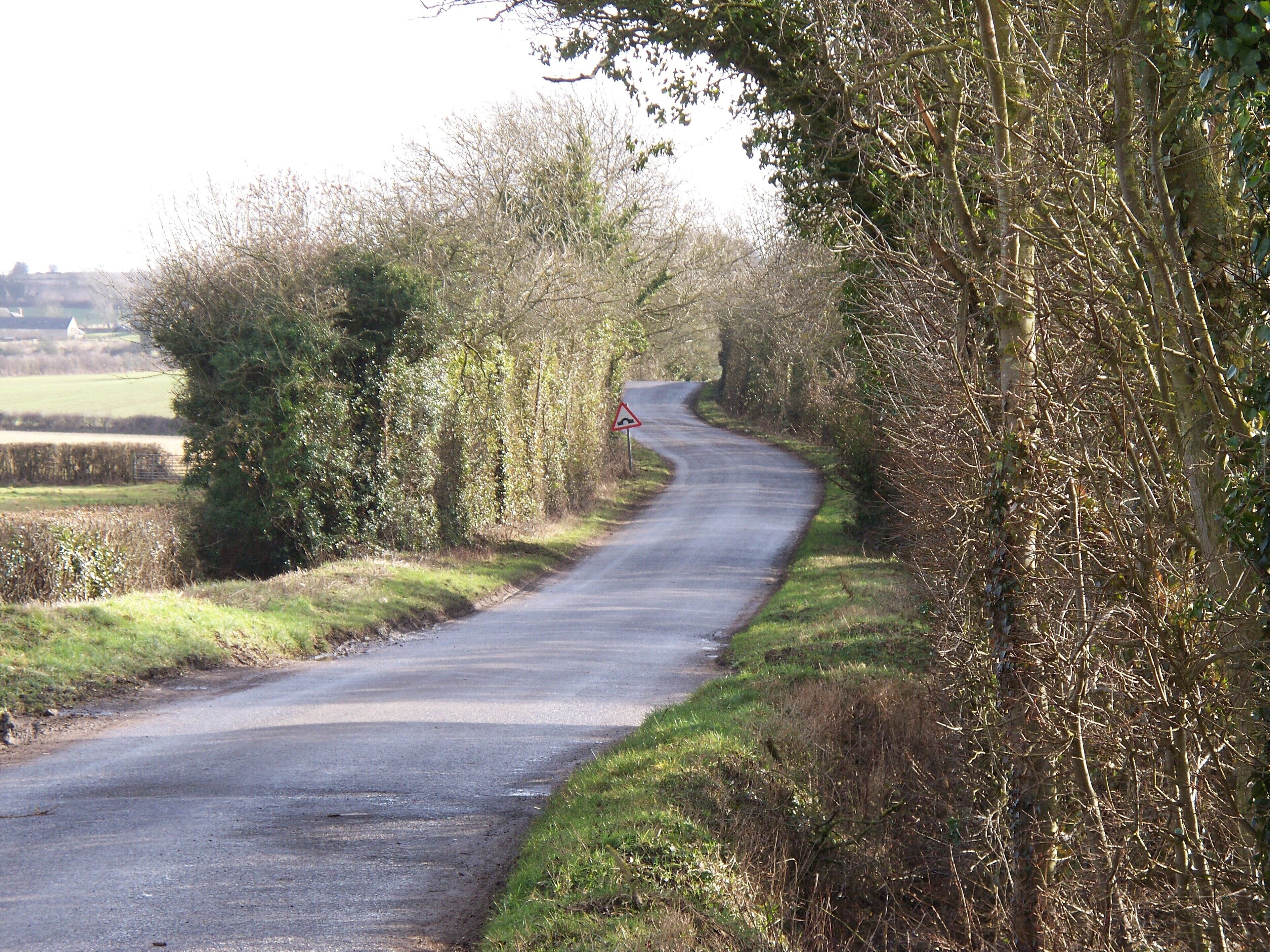 Swailsford Bridge [4] In addition to the two bridges that carry streams under the road, there is a third bridge. The hump back bridge sign on the minor road towards the B4450 carries the road over the long dismantled Banbury to Cheltenham Direct railway line.