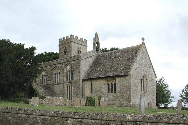 A historic stone church with a tower and arched windows.