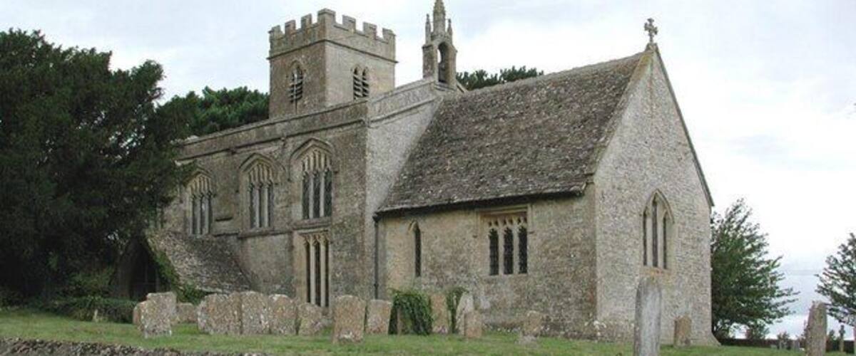 A historic stone church with a tower and arched windows.