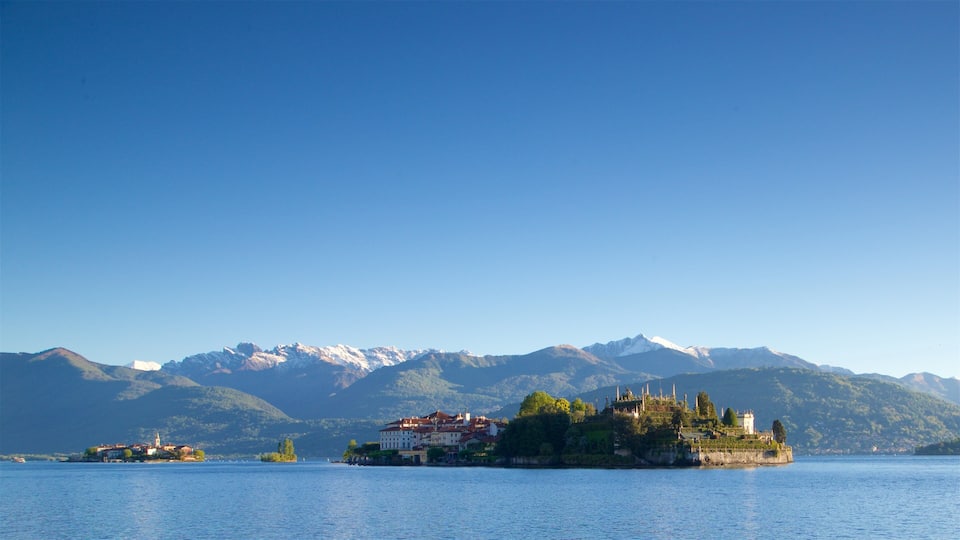 A lake with a small island featuring historic buildings and a church.