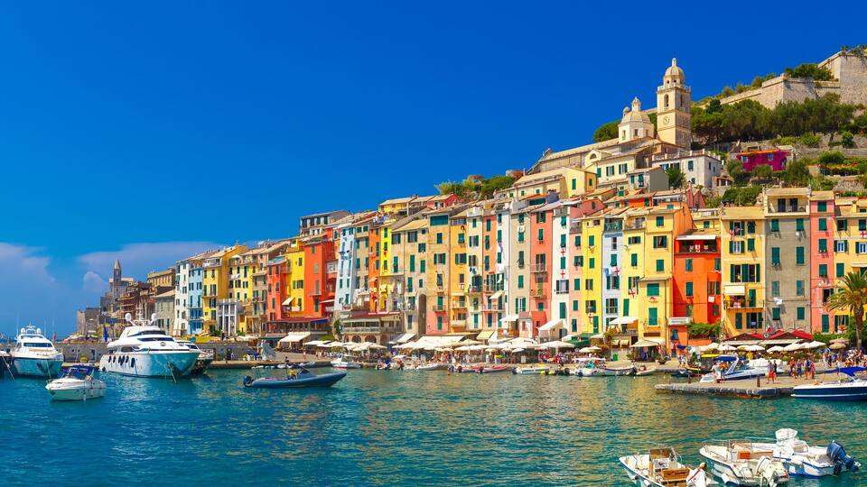 Panorama of colorful picturesque harbour of Porto Venere with San Lorenzo church, Doria Castle and Gothic Church of St. Peter, Italian Riviera, Liguria, Italy.