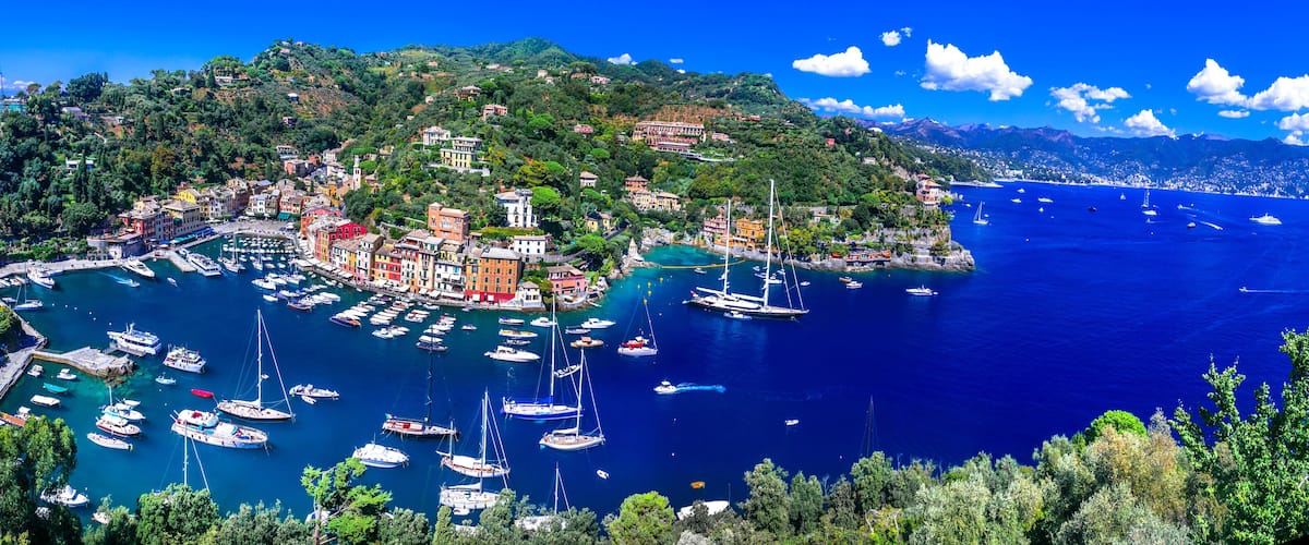 most beautiful coastal towns of Italy - luxury Portofino in Liguria, Panoramic view with colorful houses and sailing boats