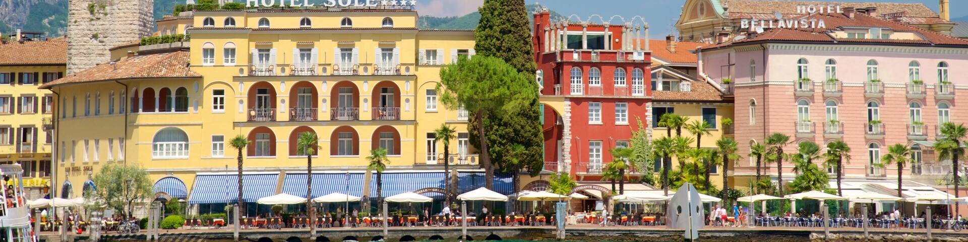 A coastal town with a prominent clock tower, Hotel Sole, and Hotel Bellavista.