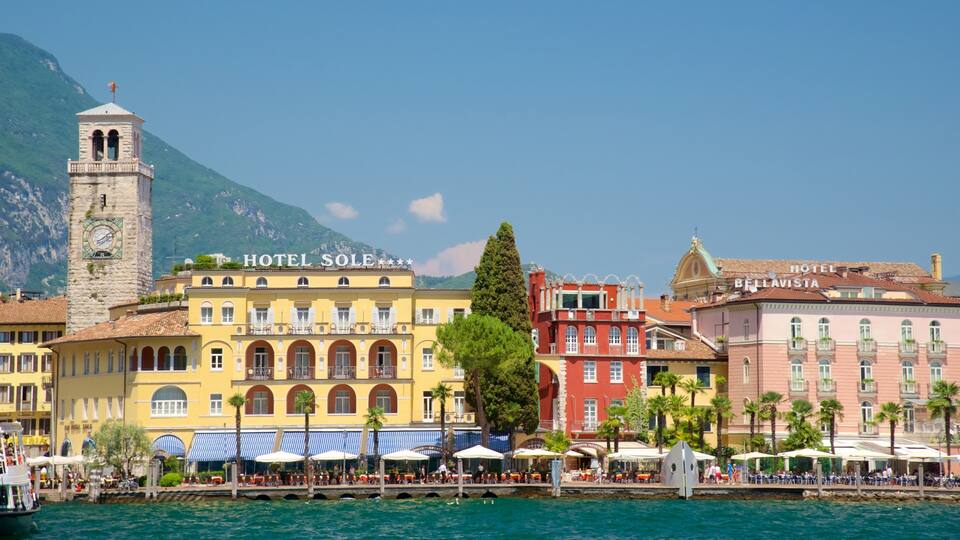 A coastal town with a prominent clock tower, Hotel Sole, and Hotel Bellavista.