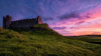 Another sunset: Roche Castle staring at relish and pinkish Sunset in County Louth, Ireland