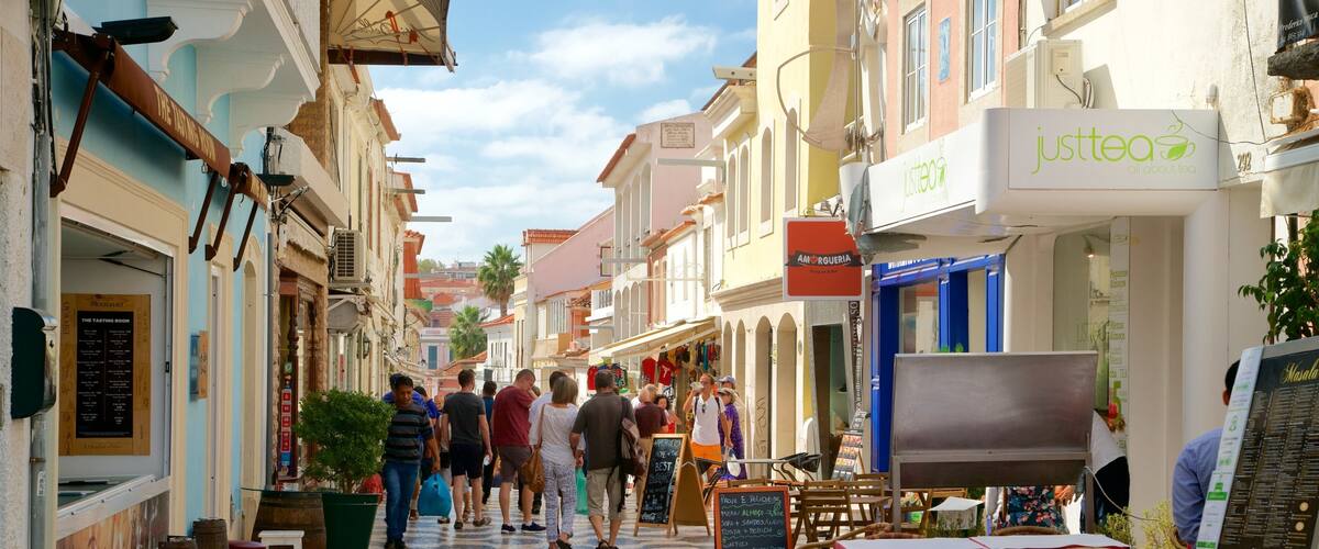 A bustling street with shops and cafes, including 'Justtea' and 'Amorguera'.
