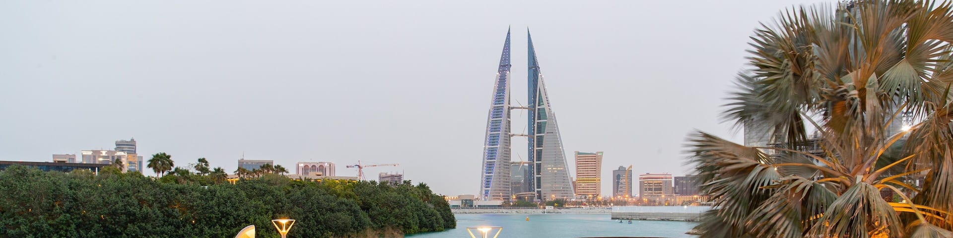 Manama which includes modern architecture, a high rise building and a bay or harbor